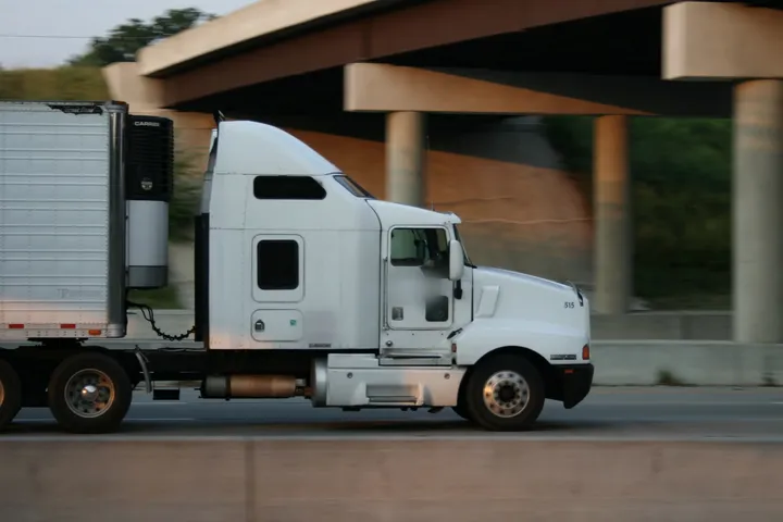 Semi truck moving fast on an interstate highway