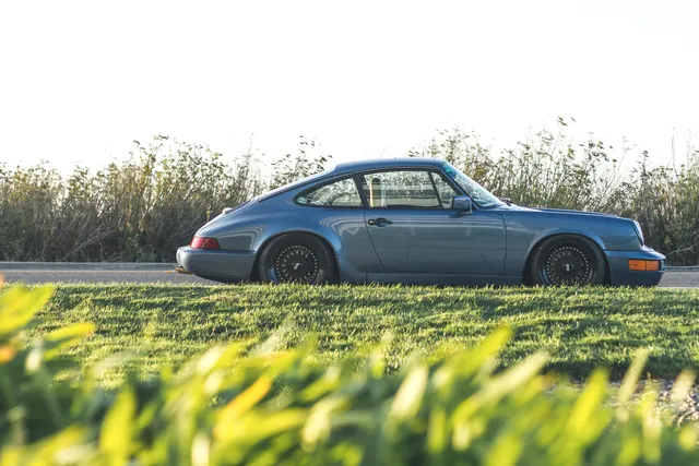 Classic sports car in side profile on a grassy field