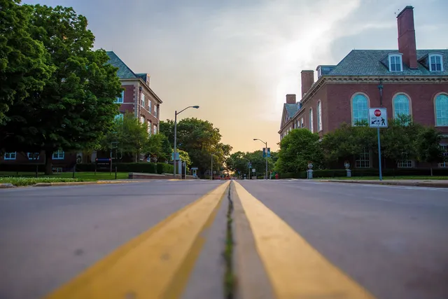 Road running between brick buildings on a university campus